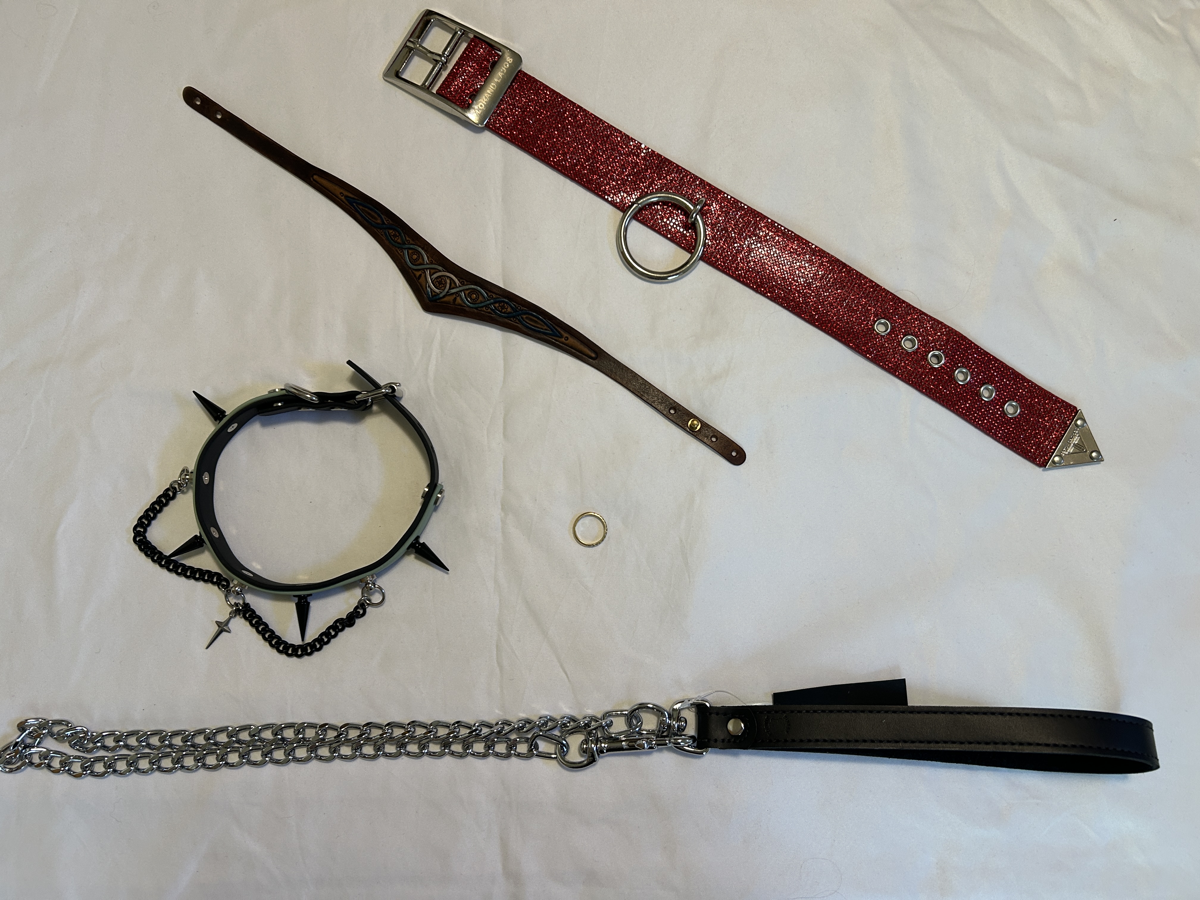 Three collars rest on white sheet